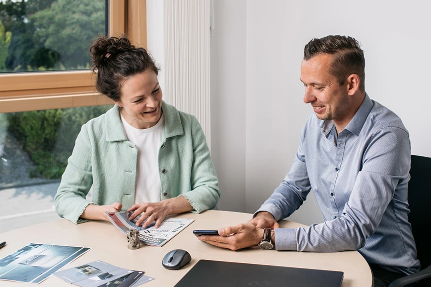 ACI Laser Marketing Team at the table with print media, laptop, flyer and cell phone