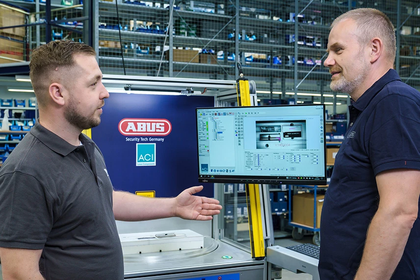 ACI employee explains the installed laser system to customers