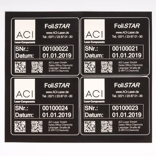 Laser marking of an ablation film for the production of labels