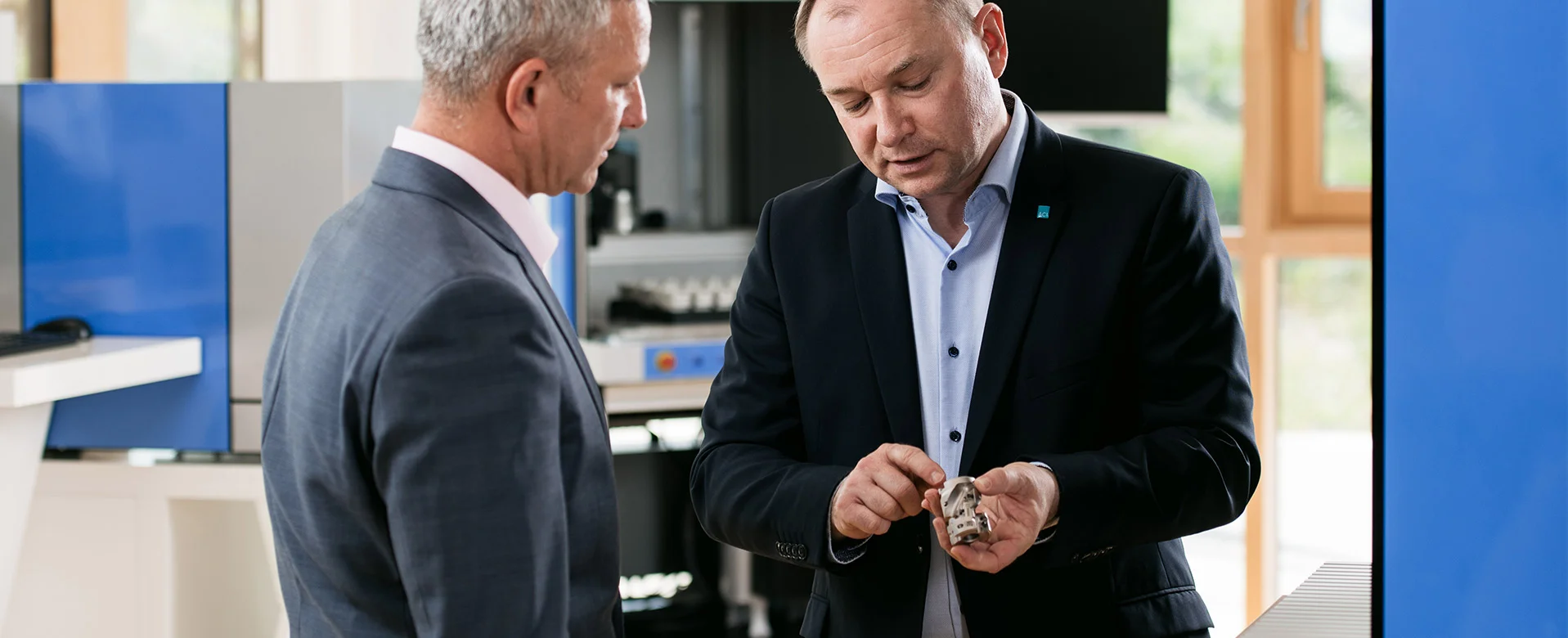 ACI sales staff and customers examine labeling samples in the showroom