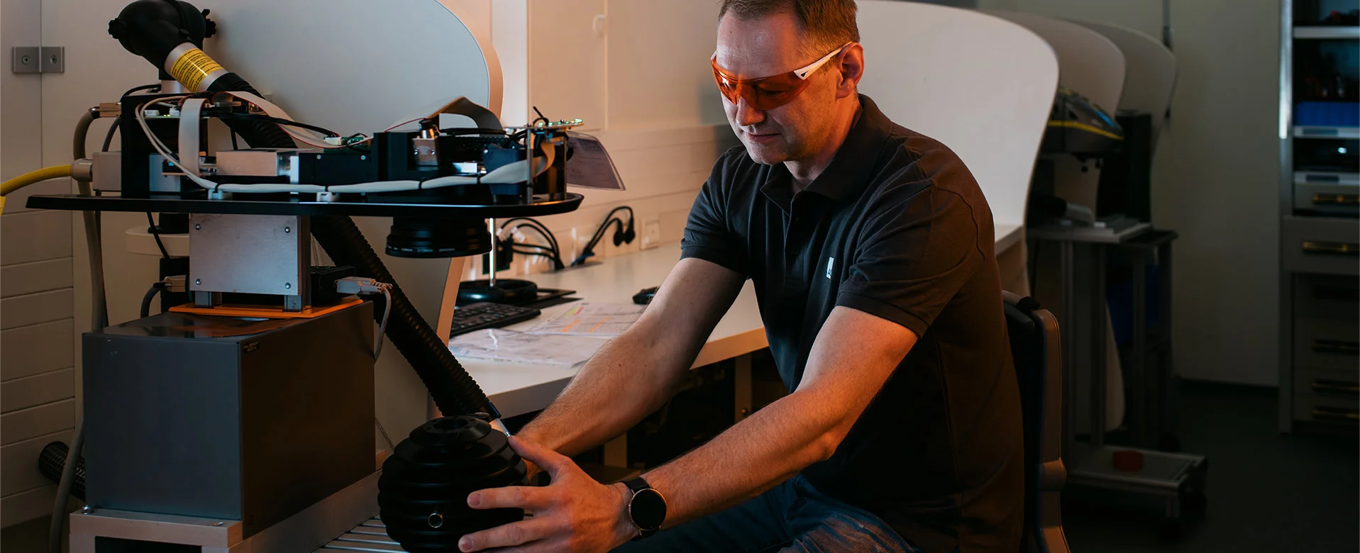 ACI Laser Quality Assurance - Employees inspecting a laser system