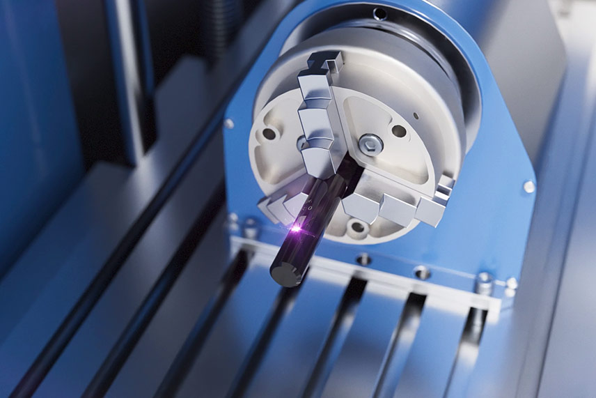 Drehmodul in einer Laserstation mit eingespanntem zylindrischem Bauteil bei der Laserbeschriftung